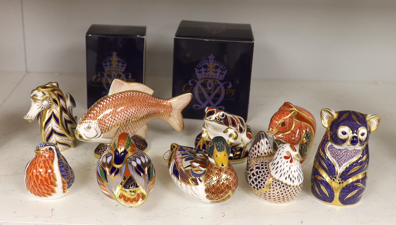 A collection of nine Royal Crown Derby paperweights